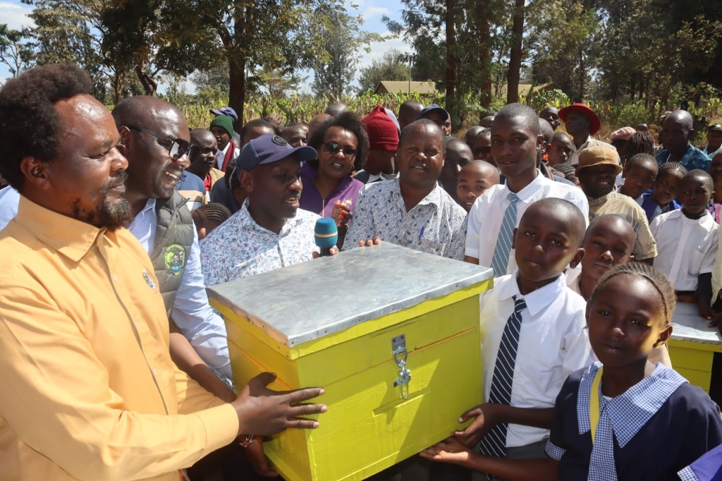 Students receiving beehives for sustainable livelihood at Egoji